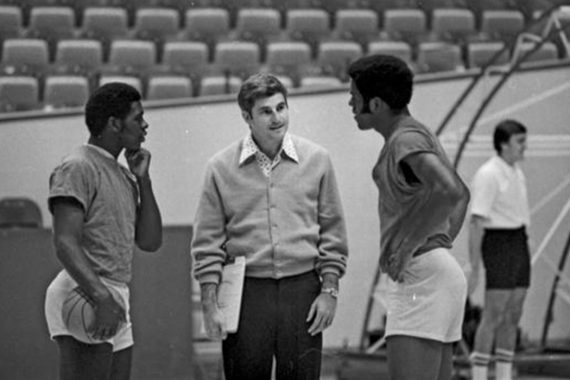 Bob Knight standing with two basketball players