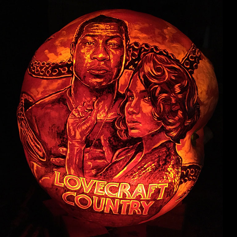 The stars of Lovecraft Country depicted on a pumpkin